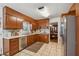 Functional kitchen featuring wood cabinets, linoleum flooring, and stainless steel appliances at 4453 Abingdon Dr, Stone Mountain, GA 30083