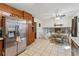 Bright kitchen features stainless steel refrigerator, wooden cabinets, and adjacent dining area at 4453 Abingdon Dr, Stone Mountain, GA 30083