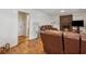 Inviting living room featuring a brick fireplace, hardwood floors, and a cozy seating area with leather furniture at 4453 Abingdon Dr, Stone Mountain, GA 30083