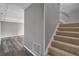 Finished basement with modern wood-look flooring and access to carpeted stairs at 4701 Flat Shoals Rd # 49C, Union City, GA 30291