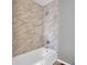 Bathroom featuring a marble-look tiled shower with a tub and modern fixtures at 4701 Flat Shoals Rd # 49C, Union City, GA 30291