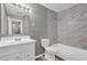 Bathroom with white vanity, toilet, gray walls, and tile shower at 4701 Flat Shoals Rd # 49C, Union City, GA 30291