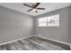 A bright bedroom features a window, ceiling fan, and complementary wood-look flooring at 4701 Flat Shoals Rd # 49C, Union City, GA 30291