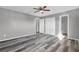 Bedroom showcasing wood-look floors, closet, modern ceiling fan, and ensuite bathroom access at 4701 Flat Shoals Rd # 49C, Union City, GA 30291