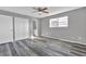 Bedroom with modern ceiling fan, wood-look floors, closet and ensuite bathroom access at 4701 Flat Shoals Rd # 49C, Union City, GA 30291