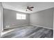 Bedroom featuring wood-look floors, a modern ceiling fan, and a bright window at 4701 Flat Shoals Rd # 49C, Union City, GA 30291