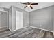 Bedroom with gray walls, ceiling fan, and stylish gray wood-look flooring at 4701 Flat Shoals Rd # 49C, Union City, GA 30291