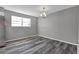 Dining area with a chandelier and gray plank flooring next to the kitchen at 4701 Flat Shoals Rd # 49C, Union City, GA 30291