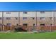 Townhome exterior featuring a combination of brick and siding, fenced yard and green grass at 4701 Flat Shoals Rd # 49C, Union City, GA 30291