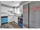 Kitchen showcasing white cabinetry, stainless appliances and gray plank flooring at 4701 Flat Shoals Rd # 49C, Union City, GA 30291