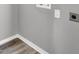 Close-up view of laundry room hook ups with gray plank flooring at 4701 Flat Shoals Rd # 49C, Union City, GA 30291