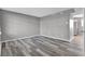 An empty room is filled with stylish gray wood-look flooring at 4701 Flat Shoals Rd # 49C, Union City, GA 30291