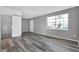 Open living room with a large window and gray plank flooring at 4701 Flat Shoals Rd # 49C, Union City, GA 30291