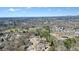 Aerial view shows a home nestled in a tree-lined neighborhood, near roads and green expanses at 1090 Compton Way, Suwanee, GA 30024