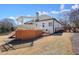 Backyard view of deck and lush surroundings shows ample space for outdoor living and entertainment at 1090 Compton Way, Suwanee, GA 30024