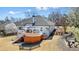 Well-maintained backyard with a spacious deck, dining area, and mature trees providing privacy at 1090 Compton Way, Suwanee, GA 30024