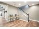 A finished basement with wooden floors, and a stairway at 1090 Compton Way, Suwanee, GA 30024