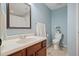 A bathroom with blue walls and a mirror at 1090 Compton Way, Suwanee, GA 30024