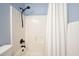 Clean bathroom with a shower featuring a shower head and white shower curtain at 1090 Compton Way, Suwanee, GA 30024