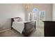 Inviting bedroom with soft carpet, neutral walls, large windows and stylish chandelier at 1090 Compton Way, Suwanee, GA 30024
