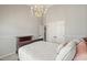 Cozy bedroom with a comfortable bed, chandelier lighting and ample closet space at 1090 Compton Way, Suwanee, GA 30024