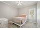 Comfortable bedroom with soft carpet, neutral walls, window, ceiling fan and dresser at 1090 Compton Way, Suwanee, GA 30024