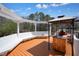 Spacious deck featuring built-in seating, a charming pergola, and a convenient grilling station at 1090 Compton Way, Suwanee, GA 30024