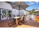 Outdoor deck with dining table, umbrella, and white railing; great for enjoying the outdoors at 1090 Compton Way, Suwanee, GA 30024