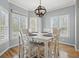 Bright dining nook with a stylish light fixture and multiple windows that offer natural light at 1090 Compton Way, Suwanee, GA 30024