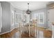 Cozy dining area with a white table, matching chairs, and natural light from surrounding windows at 1090 Compton Way, Suwanee, GA 30024