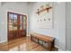 Inviting entryway featuring wood-look tile flooring, storage bench, and decorative wall accents at 1090 Compton Way, Suwanee, GA 30024