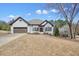 Charming home featuring a brick exterior, a two-car garage, and a front yard at 1090 Compton Way, Suwanee, GA 30024