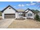 Charming one-story brick home featuring a two-car garage and well-manicured lawn at 1090 Compton Way, Suwanee, GA 30024