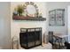Close-up of a charming fireplace with a decorative mirror, rustic wood mantel, and lanterns at 1090 Compton Way, Suwanee, GA 30024