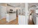 Well-lit kitchen with white cabinetry, granite countertops, stainless steel appliances, and pantry access at 1090 Compton Way, Suwanee, GA 30024