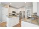 Bright kitchen featuring white cabinets, granite countertops, stainless steel appliances, and an island sink at 1090 Compton Way, Suwanee, GA 30024