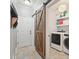 Well-lit laundry area with modern washer and dryer behind a sliding barn door at 1090 Compton Way, Suwanee, GA 30024