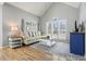 Bright living room with hardwood floors, large windows, a comfortable sofa, and a custom cabinet at 1090 Compton Way, Suwanee, GA 30024