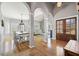 Open-concept living and dining area with hardwood floors, natural light, and architectural columns at 1090 Compton Way, Suwanee, GA 30024