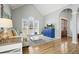 Inviting living room featuring hardwood floors, vaulted ceilings, a neutral sofa, and a custom cabinet at 1090 Compton Way, Suwanee, GA 30024