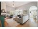 Open living room with hardwood floors, light gray walls, and a comfortable sectional couch at 1090 Compton Way, Suwanee, GA 30024