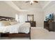 Bright main bedroom with carpet, tray ceiling, and dark wood furniture at 1090 Compton Way, Suwanee, GA 30024