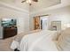 Spacious main bedroom shows en suite access, tray ceilings, and a rustic sliding barn door at 1090 Compton Way, Suwanee, GA 30024