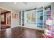 Well-lit office/flex space with custom built-ins, hardwood floors, and large windows at 1090 Compton Way, Suwanee, GA 30024