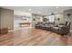 Open recreation room with a pool table, large sectional couch, and hardwood flooring at 1090 Compton Way, Suwanee, GA 30024