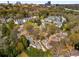 An aerial view of a luxury neighborhood with mature trees and lush greenery and the city in the background at 3582 Grove Gate Ln, Atlanta, GA 30339