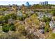 An aerial view of a lush neighborhood with mature trees and landscaping with the city skyline in the background at 3582 Grove Gate Ln, Atlanta, GA 30339