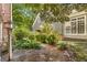 Beautiful backyard with mature trees and flowering bushes along a gravel walking path at 3582 Grove Gate Ln, Atlanta, GA 30339