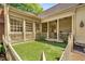Landscaped backyard featuring a covered porch and well-maintained lawn at 3582 Grove Gate Ln, Atlanta, GA 30339