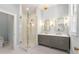 Modern bathroom featuring a glass enclosed shower, double vanity, and elegant lighting fixtures at 3582 Grove Gate Ln, Atlanta, GA 30339